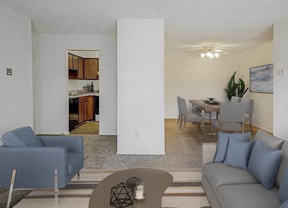 A living room with a grey couch and a blue chair at The Waverly on the Lake - Belleville, MI Apartment , Belleville, 95050