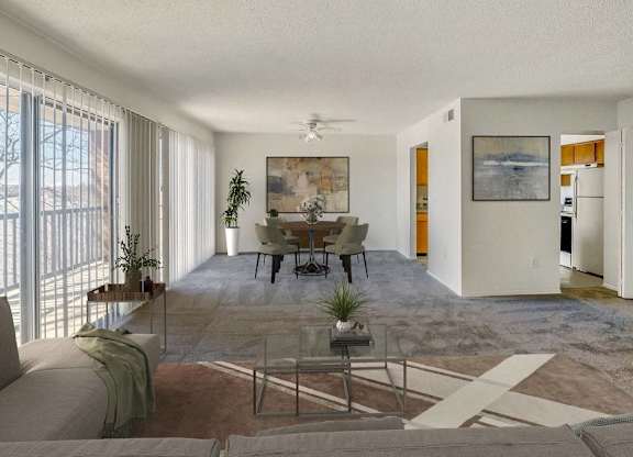 A living room with a couch, a coffee table, and a painting on the wall at The Waverly on the Lake - Belleville, MI Apartment , Michigan