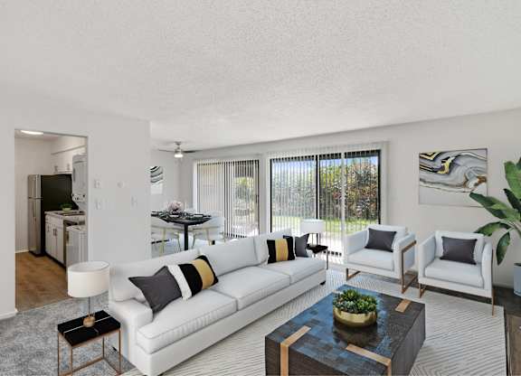 A living room with a white couch, a coffee table, and a potted plant at The Waverly on the Lake - Belleville, MI Apartment, Belleville, MI, 95050