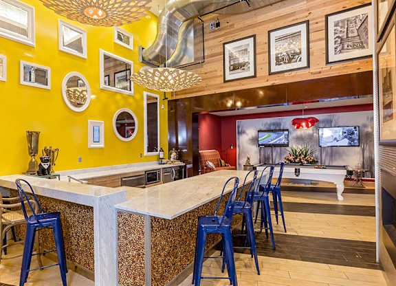 A kitchen with a yellow wall and a white counter.