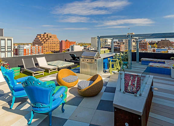 A patio with blue chairs and a woven chair.