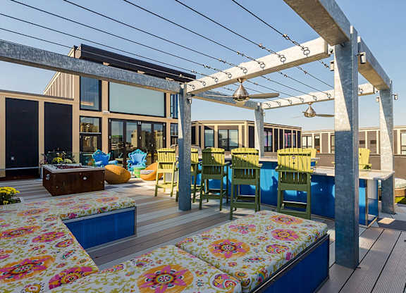 A patio with a floral mattress and chairs.