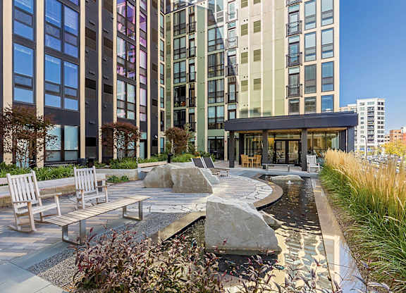 A modern building with a water feature in front.