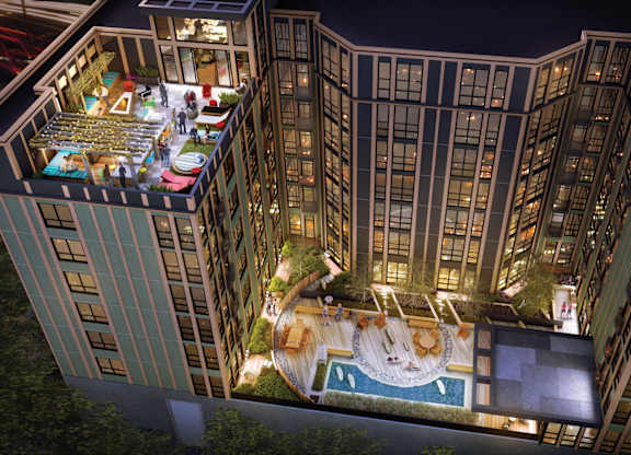 A high rise building with a pool and a garden on the roof.