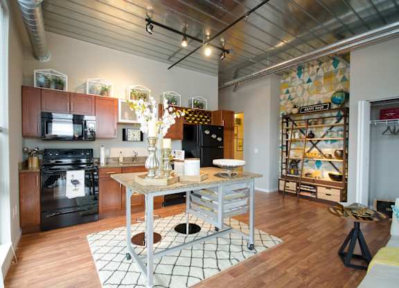 A kitchen with a black oven and a black fridge.