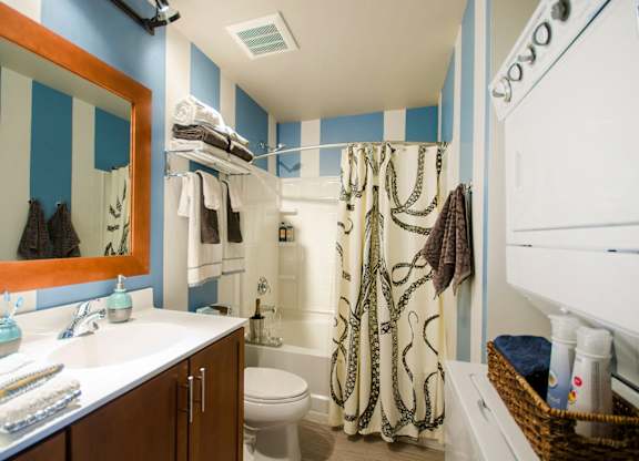 A bathroom with blue and white striped walls.