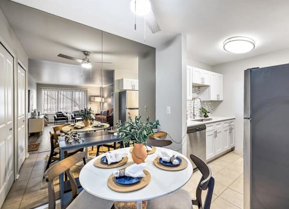 an open kitchen and dining room with a table and chairs at Town & Country Apartments - Wixom, MI, Wixom, Michigan