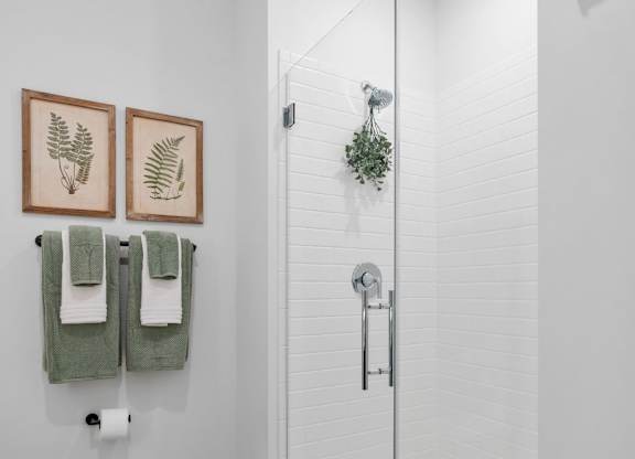 a white bathroom with a shower and a toilet at The Mera, St Louis Park, MN 55426