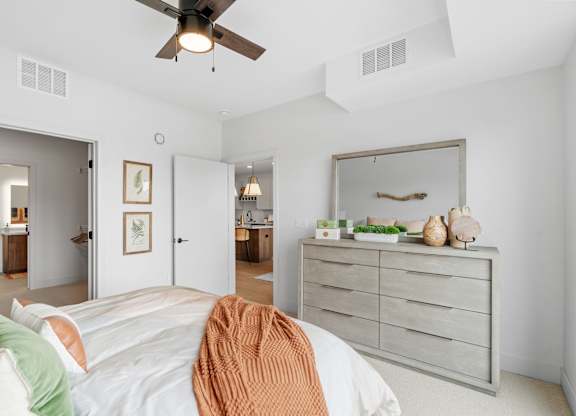 A bedroom with a queen-sized bed in a one-bedroom, one-bathroom apartment home at Lilia in Lilydale, MN 55118