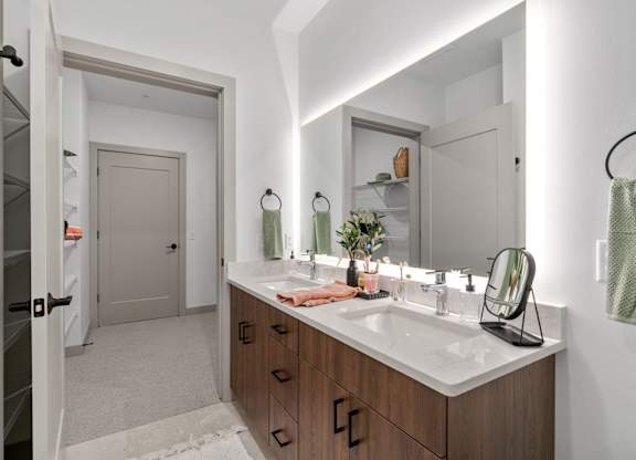 a bathroom with a large mirror and a sink at The Mera, Minnesota