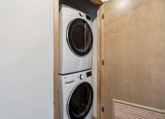 Two front loading washing machines in a laundry room.