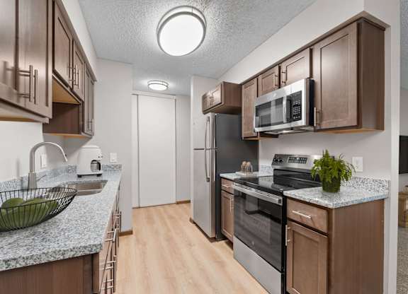 Kitchen in a renovated apartment home at Oakwood Apartments in Plymouth, MN  55447