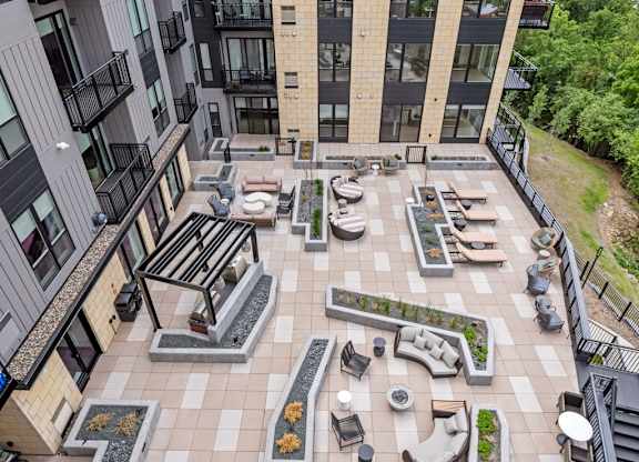 Zen Terrace with Lounge Chairs and Grills at Lilia Apartments in Lilydale, MN 55118