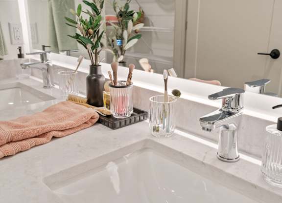 a bathroom with a sink and a mirror at The Mera, St Louis Park