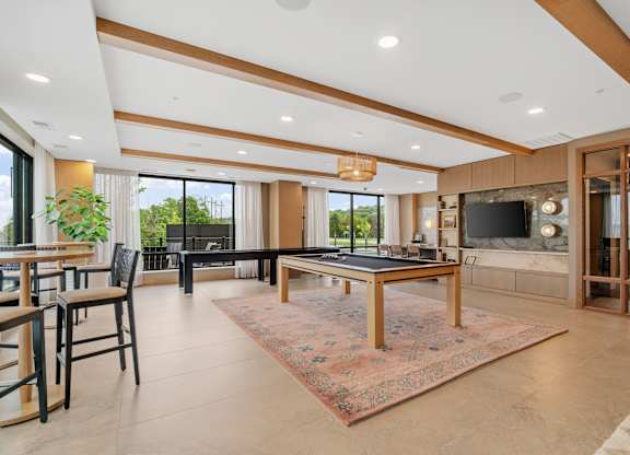 The billiards table and shuffleboard game in the Game Lounge, a reservable community room at Lilia in Lilydale, MN 55118