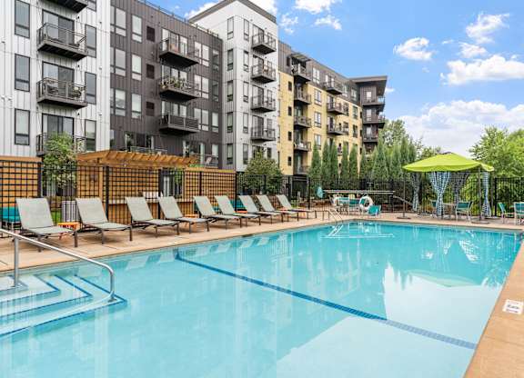our apartments have a resort style pool with lounge chairs at Be @ Axon Green, Minnesota, 55416