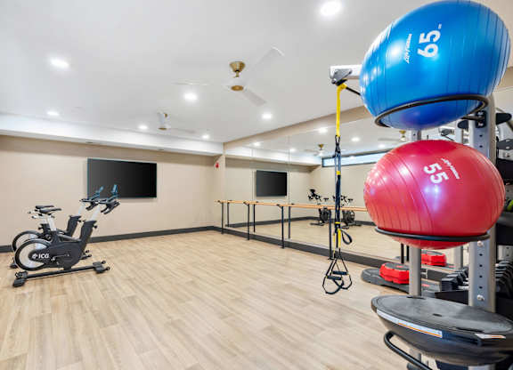 The spin and yoga studio attached to the resort-style luxury 24-hour fitness center at Lilia in Lilydale, MN 55118, with cardio equipment, free weights, and exercise machines.