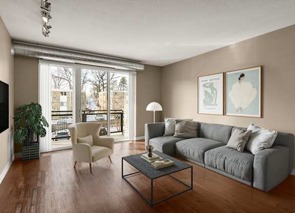a living room with a large window and a couch at Be @ Axon Green, Minneapolis, MN