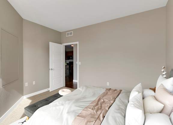 a bedroom with grey walls and white furniture at Be @ Axon Green, Minnesota