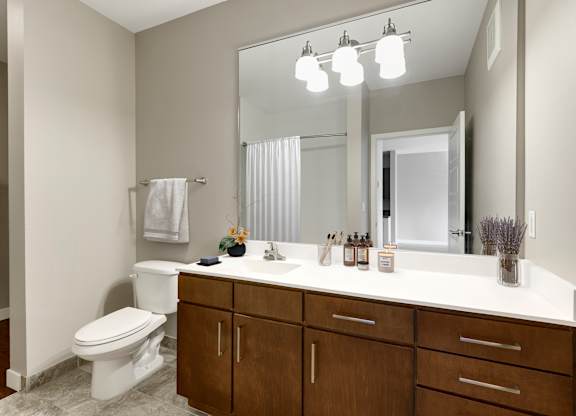 a bathroom with a large mirror at Be @ Axon Green, Minneapolis