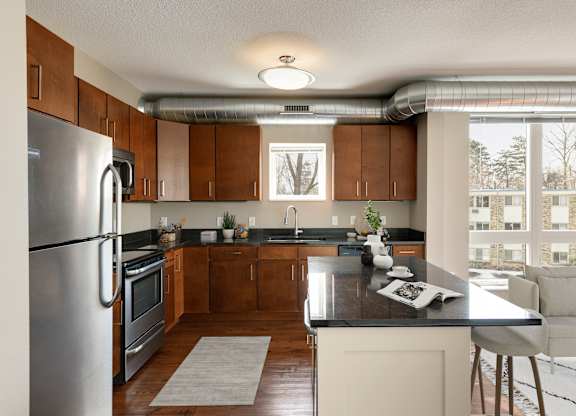a kitchen and living room in a 555 waverly unit at Be @ Axon Green, Minneapolis, 55416
