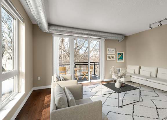 a living room with couches and a coffee table at Be @ Axon Green, Minneapolis, 55416