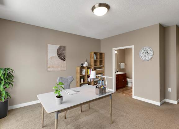 a home office with a large potted plant on the side of the desk at Be @ Axon Green, Minneapolis, Minnesota