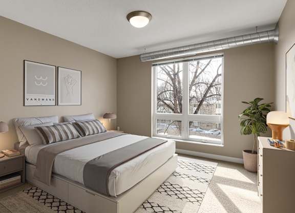 a bedroom with a large window and a bed at Be @ Axon Green, Minnesota, 55416