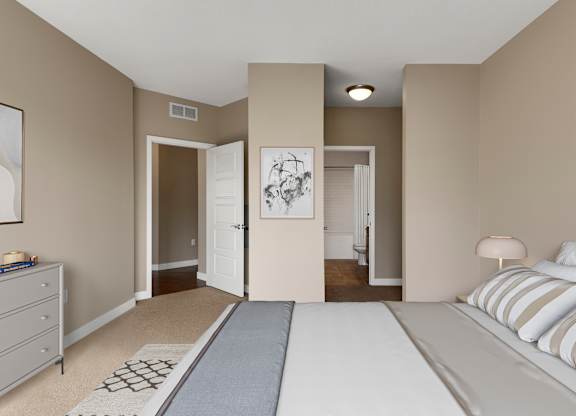 a bedroom with a large bed and a nightstand with a lamp at Be @ Axon Green, Minneapolis, 55416