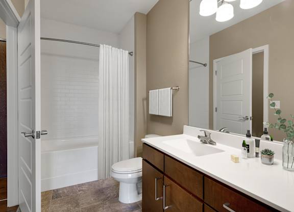 a bathroom with a shower toilet and sink at Be @ Axon Green, Minneapolis, MN