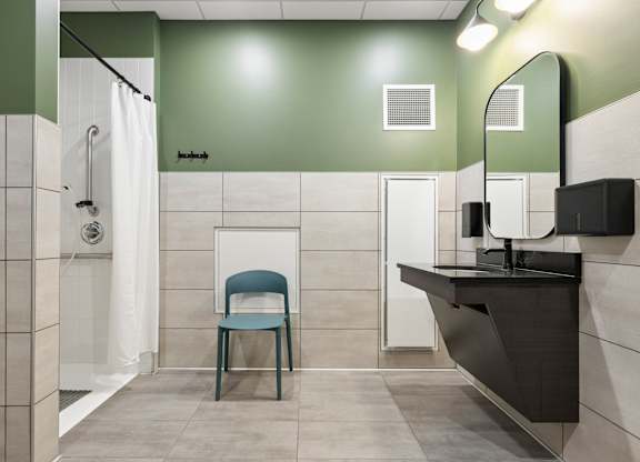 A bathroom with a chair and a sink.