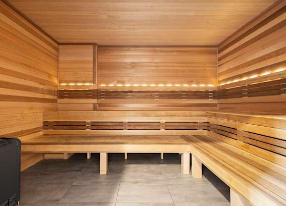 A sauna with wooden benches and walls.