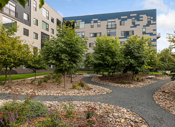 A modern building with a garden in front.