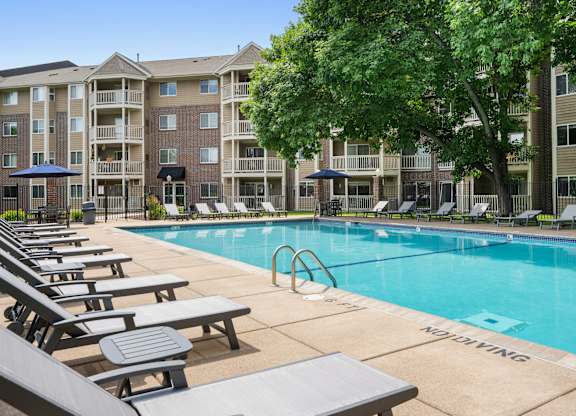 our apartments offer a swimming pool with lounge chairs at Cityscape, St Louis Park, MN