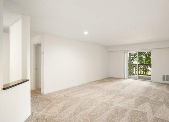 the living room and dining room of a house with white walls and a large window at Cityscape, St Louis Park, MN