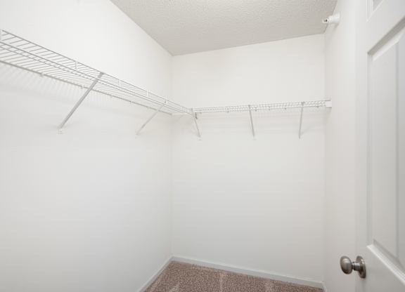 an empty closet with a metal rack on the wall at Cityscape, St Louis Park, MN, 55416