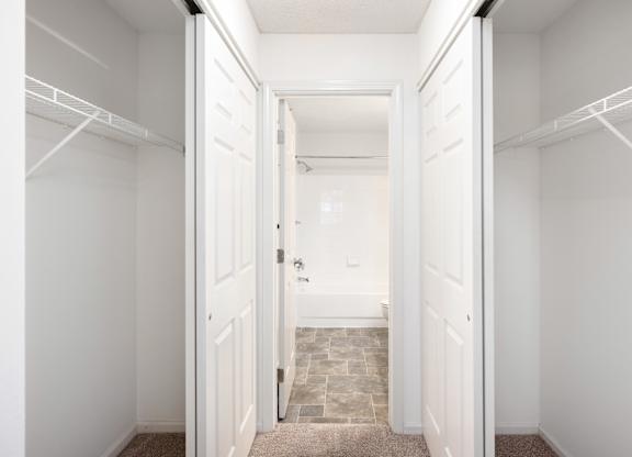 a closet in a bedroom with white doors at Cityscape, St Louis Park, MN, 55416