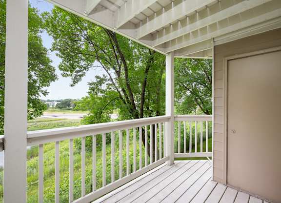 the view from the deck of a house with a door open to a porch at Cityscape, St Louis Park, 55416