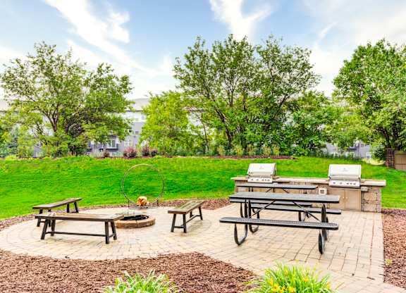 picnic area with picnic tables and barbecue grill at Cityscape, Minnesota, 55416