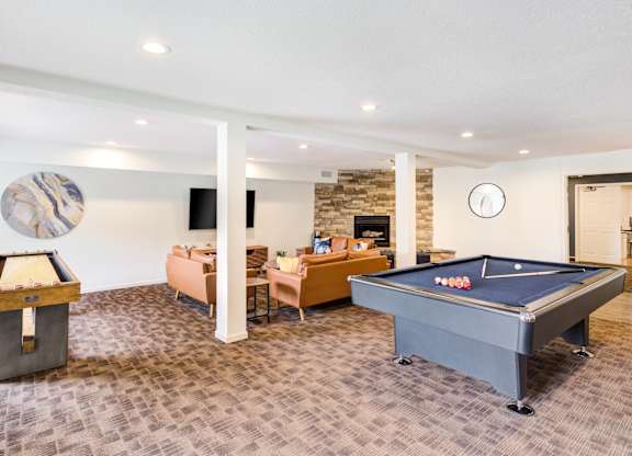 a game room with a pool table and a tv at Cityscape, St Louis Park, 55416