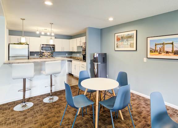 a dining room with a kitchen with a table and chairs at Cityscape, St Louis Park, Minnesota