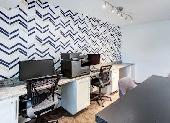 an office with desks and chairs and a wall with a checkered wallpaper at Cityscape, St Louis Park, MN