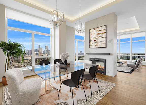 a dining room with a glass table and chairs and a fireplace at Expo, Minneapolis Minnesota