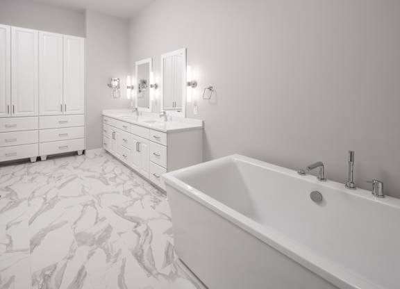 a large white bathroom with a tub and two sinks at Expo, Minneapolis, MN