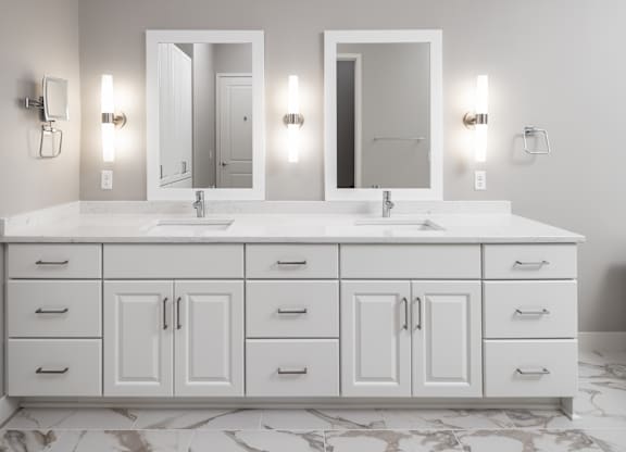 a white bathroom with two sinks and two mirrors at Expo, Minneapolis, 55414