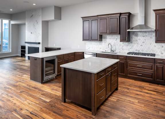 a large kitchen with wooden floors and wooden cabinets at Expo, Minneapolis Minnesota