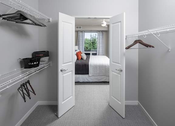 a bedroom with a bed and a closet with a door open at Expo, Minneapolis