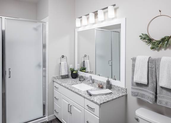 a bathroom with a sink and a shower and a mirror at Expo, Minneapolis, MN 55414
