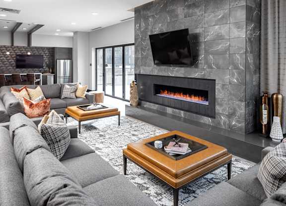 a living room with a gray couch and a fireplace at Expo, Minnesota