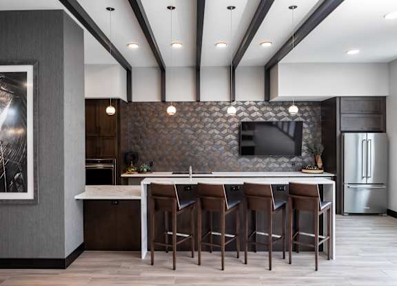 a kitchen with a large island with stools and a tv at Expo, Minnesota, 55414